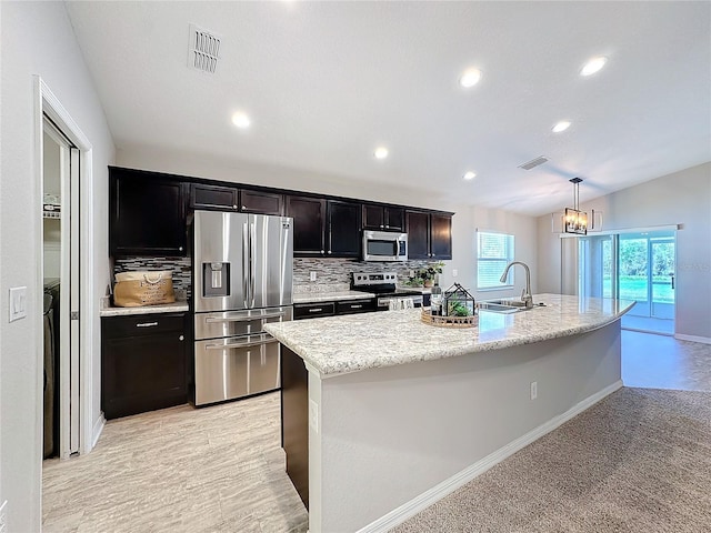 kitchen with tasteful backsplash, visible vents, appliances with stainless steel finishes, and a sink