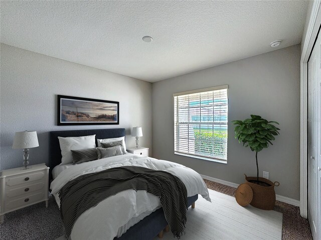 bedroom featuring baseboards and a textured ceiling