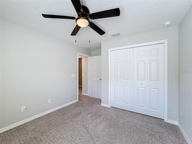 unfurnished bedroom featuring visible vents, a ceiling fan, a textured ceiling, carpet flooring, and baseboards