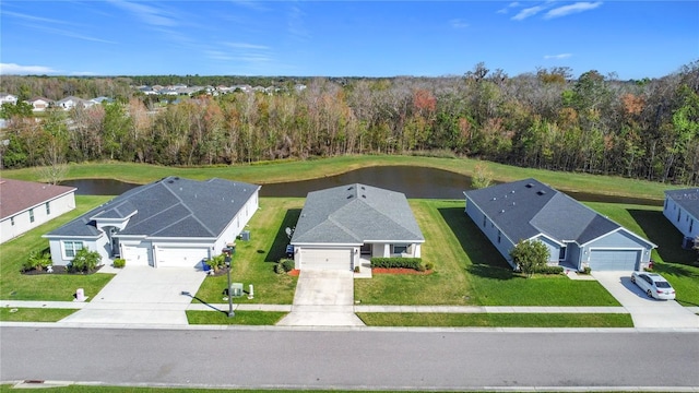 aerial view with a wooded view and a water view