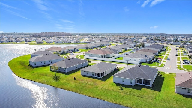 drone / aerial view featuring a residential view and a water view