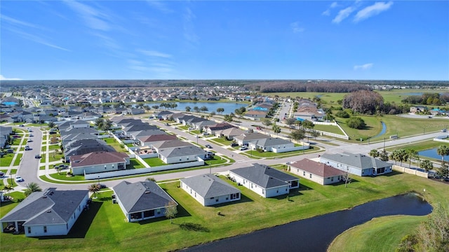 birds eye view of property featuring a water view and a residential view