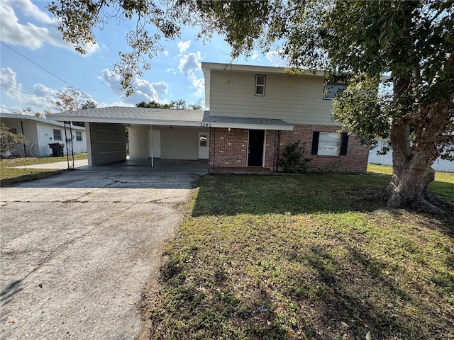 view of property featuring a front lawn and a carport