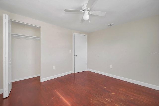 unfurnished bedroom featuring dark hardwood / wood-style floors and ceiling fan