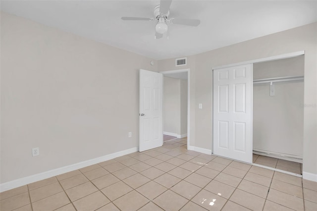 unfurnished bedroom featuring light tile patterned flooring, ceiling fan, and a closet