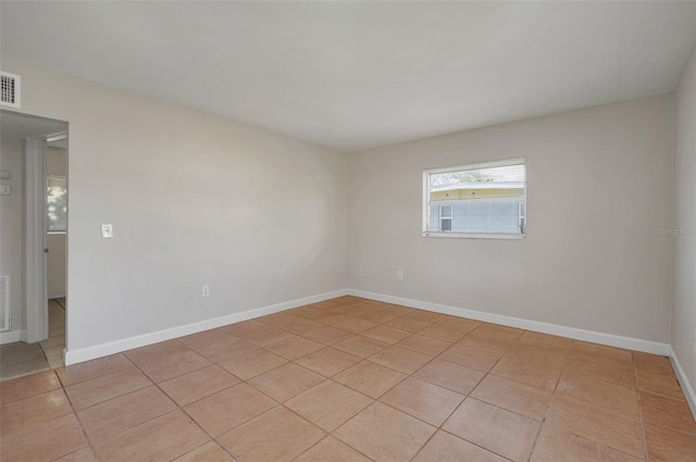 spare room featuring light tile patterned floors