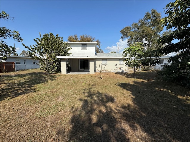 rear view of house with a yard and a patio area