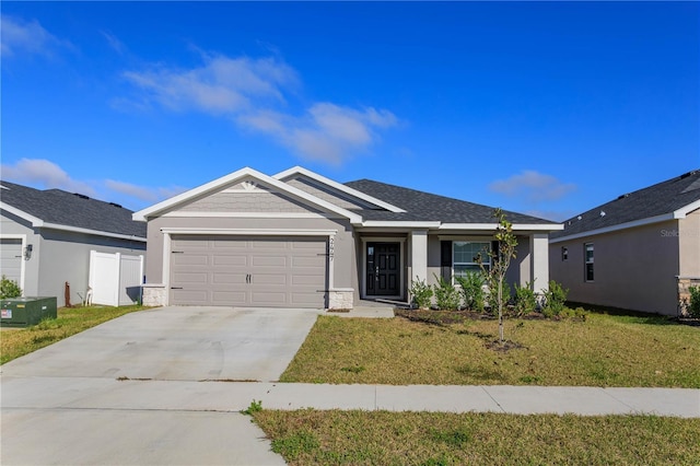 ranch-style house with a garage and a front lawn