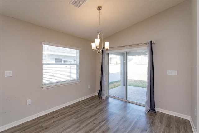 unfurnished room with lofted ceiling, dark hardwood / wood-style flooring, and a chandelier