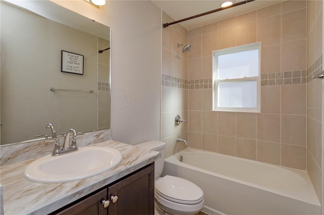 full bathroom with vanity, toilet, and tiled shower / bath