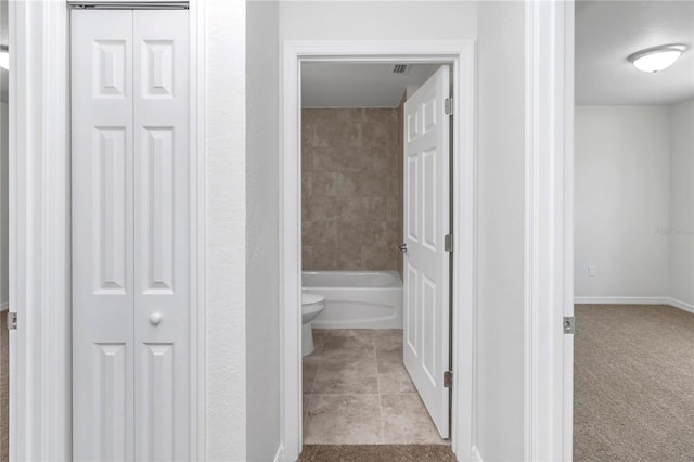 bathroom featuring tile patterned flooring and toilet