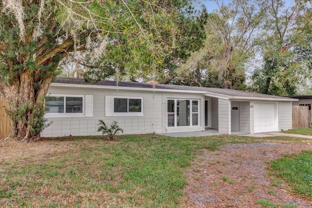 back of house featuring a yard and a garage