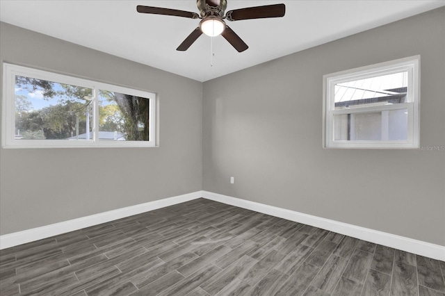 spare room with ceiling fan and dark hardwood / wood-style flooring