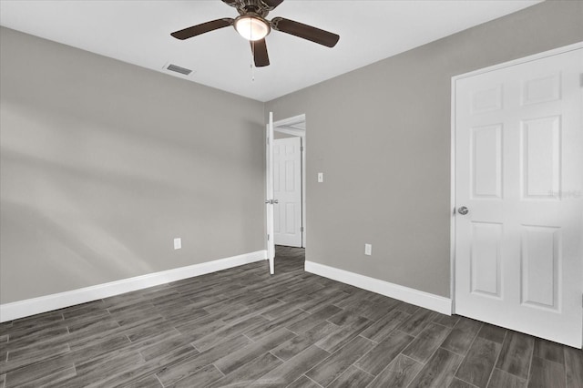 unfurnished bedroom with dark hardwood / wood-style flooring and ceiling fan