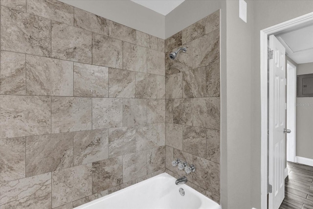 bathroom featuring hardwood / wood-style floors and tiled shower / bath