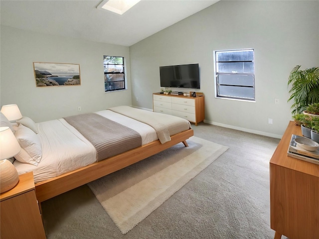 bedroom with vaulted ceiling and light carpet