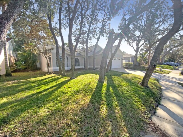 view of front of property with a garage and a front lawn