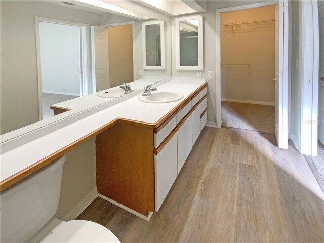 bathroom featuring hardwood / wood-style floors, toilet, and vanity