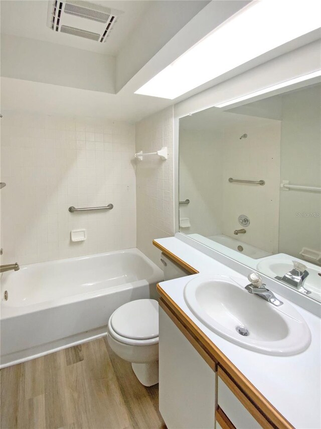 full bathroom featuring toilet, vanity, shower / bathtub combination, and wood-type flooring