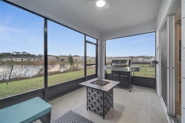 sunroom / solarium featuring a healthy amount of sunlight and a water view