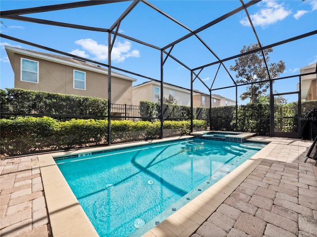 view of pool with an in ground hot tub, a lanai, and a patio