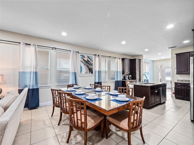 dining room featuring sink and light tile patterned floors