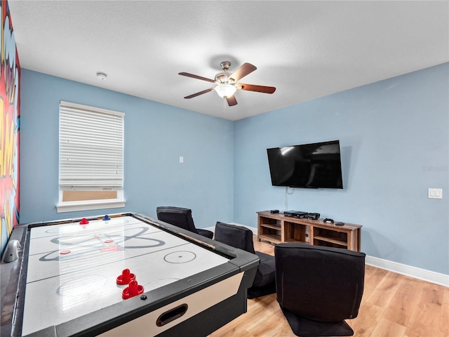 playroom featuring ceiling fan and light hardwood / wood-style flooring