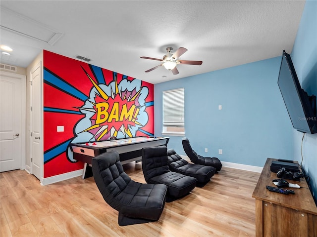 interior space featuring hardwood / wood-style floors, a textured ceiling, and ceiling fan