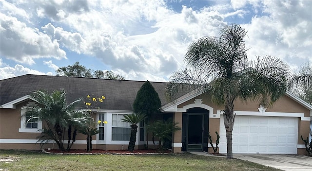 ranch-style house with stucco siding, a shingled roof, concrete driveway, a front yard, and a garage