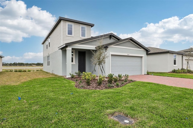 view of front of home with a garage, decorative driveway, a front yard, and stucco siding