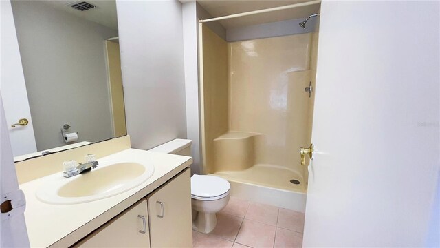 4448 Pinebark Ave Unit 56-1, Orlando, FL 32811 - bathroom with tile patterned floors, a stall shower, toilet, and vanity
