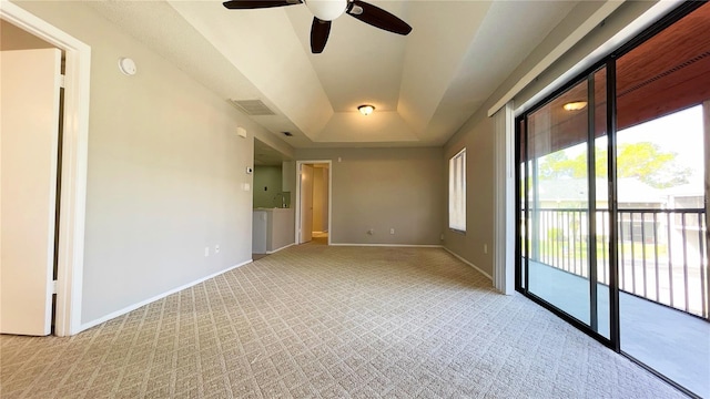 4448 Pinebark Ave Unit 56-1, Orlando, FL 32811 - empty room featuring light colored carpet, a raised ceiling, ceiling fan, and baseboards