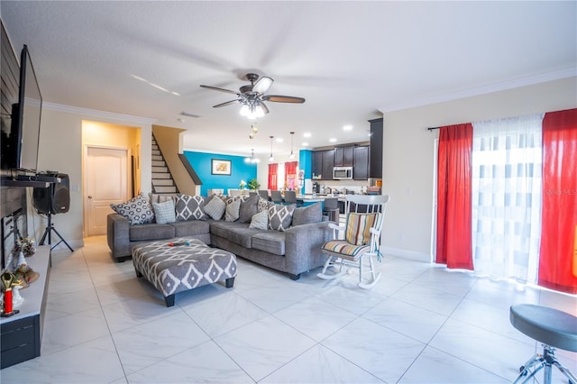 living room with crown molding and ceiling fan