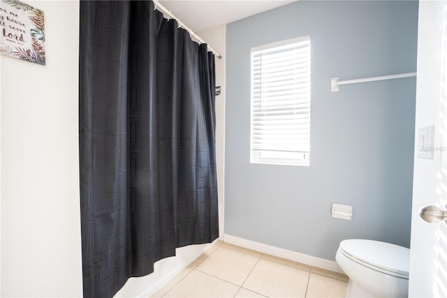 bathroom with a shower with curtain, tile patterned floors, and toilet