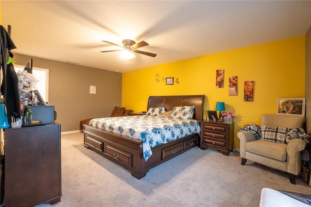 bedroom featuring light colored carpet and ceiling fan