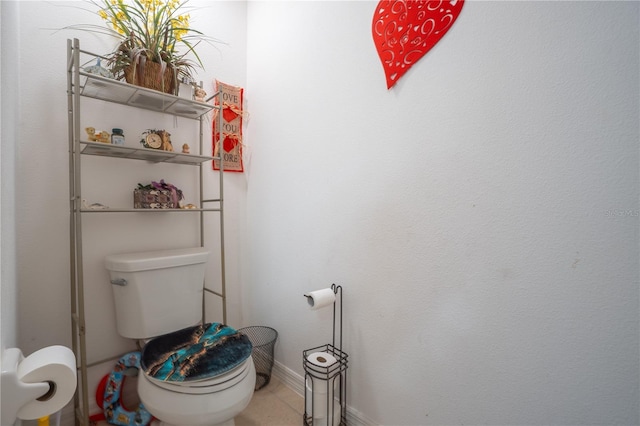 bathroom featuring toilet and tile patterned flooring