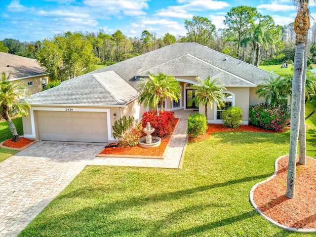 ranch-style house with stucco siding, a front lawn, decorative driveway, roof with shingles, and a garage