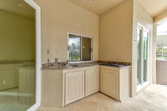 kitchen featuring sink and cream cabinetry