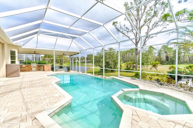 view of swimming pool featuring an in ground hot tub, a patio, and glass enclosure