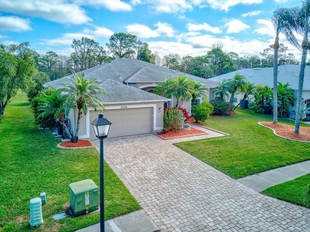 single story home featuring a garage and a front lawn