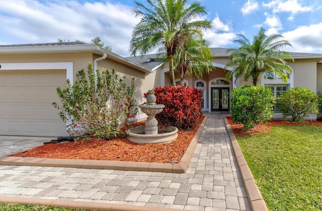 view of front of property with a garage and french doors