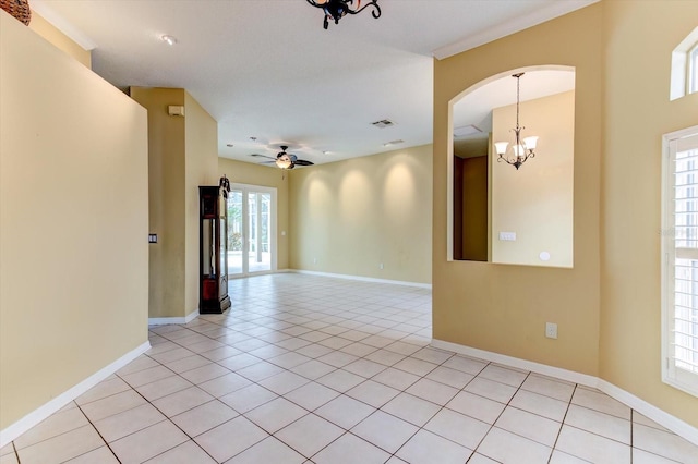 unfurnished room featuring light tile patterned floors and ceiling fan with notable chandelier