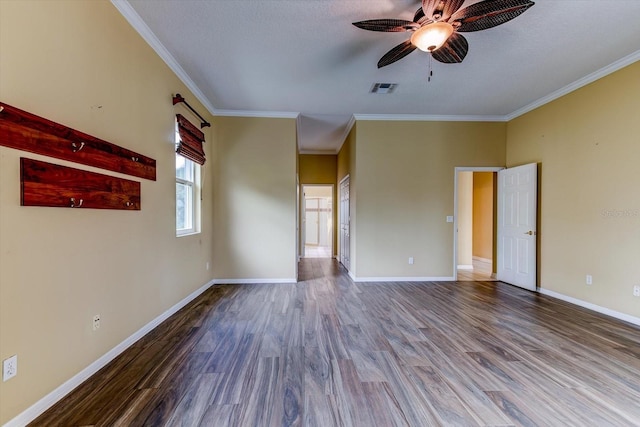 empty room with wood-type flooring, ornamental molding, a textured ceiling, and ceiling fan