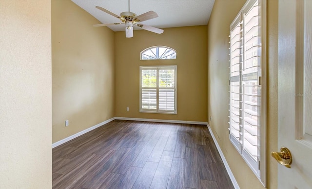 empty room featuring dark wood-type flooring and ceiling fan