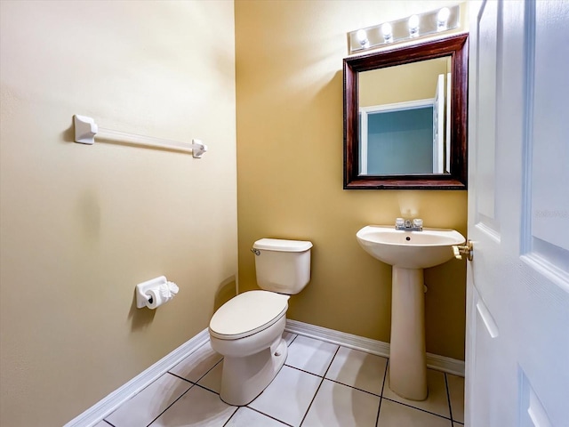 bathroom featuring tile patterned flooring, sink, and toilet