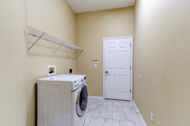 clothes washing area with washer / clothes dryer and light tile patterned floors