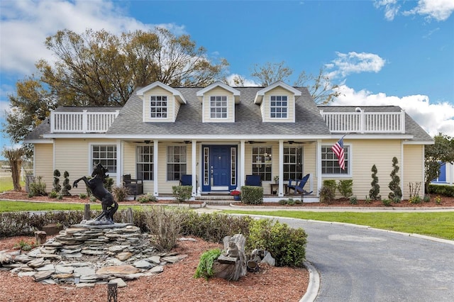 cape cod house featuring a porch