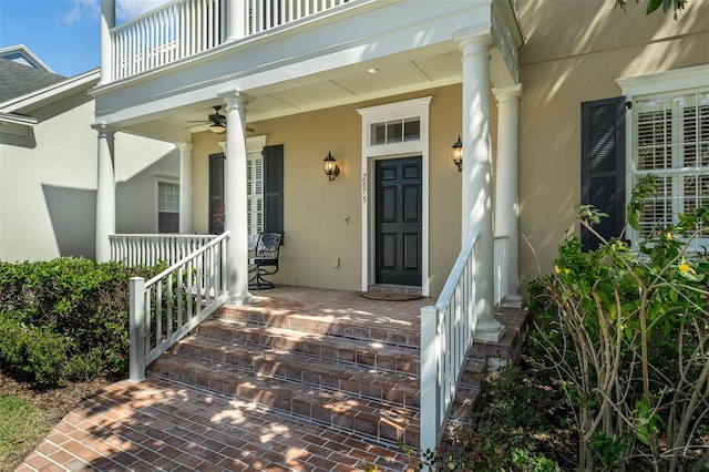 property entrance featuring a porch and stucco siding