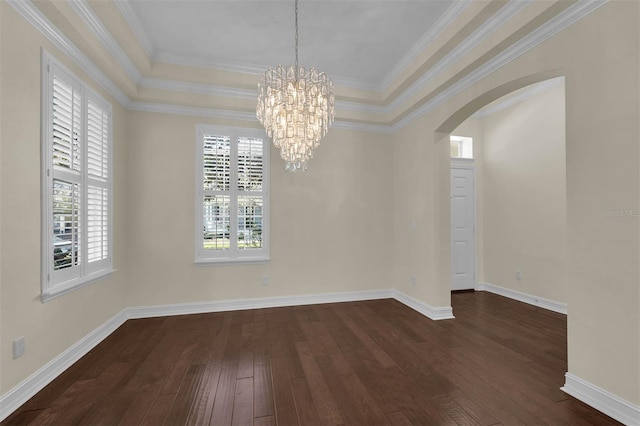 unfurnished dining area with a tray ceiling, arched walkways, dark wood-style flooring, and ornamental molding