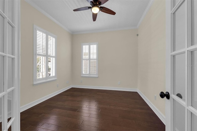 unfurnished room featuring dark wood-style floors, ornamental molding, baseboards, and ceiling fan